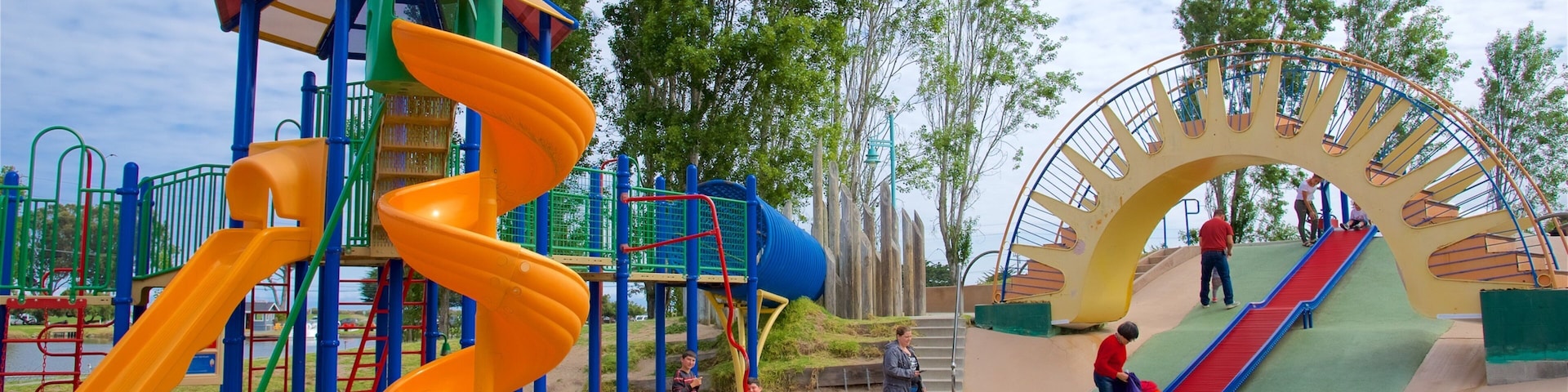 Dennis the Menace Park featuring a playground as well as children