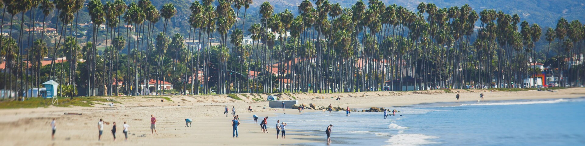 Beautiful view of Santa Barbara ocean front walk, with beach and marina, palms and mountains, Santa Ynez mountains and Pacific Ocean, Santa Barbara county, California, United States, summer sunny day
