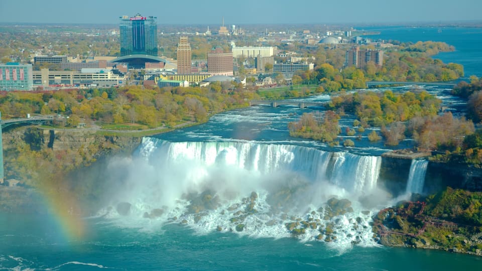 A waterfall, a cityscape, and a rainbow.