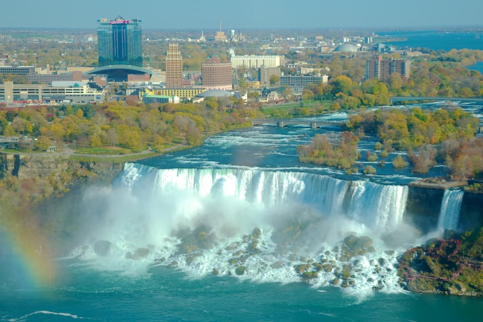 A waterfall, a cityscape, and a rainbow.