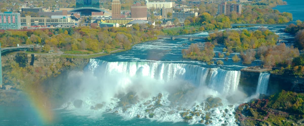 A waterfall, a cityscape, and a rainbow.