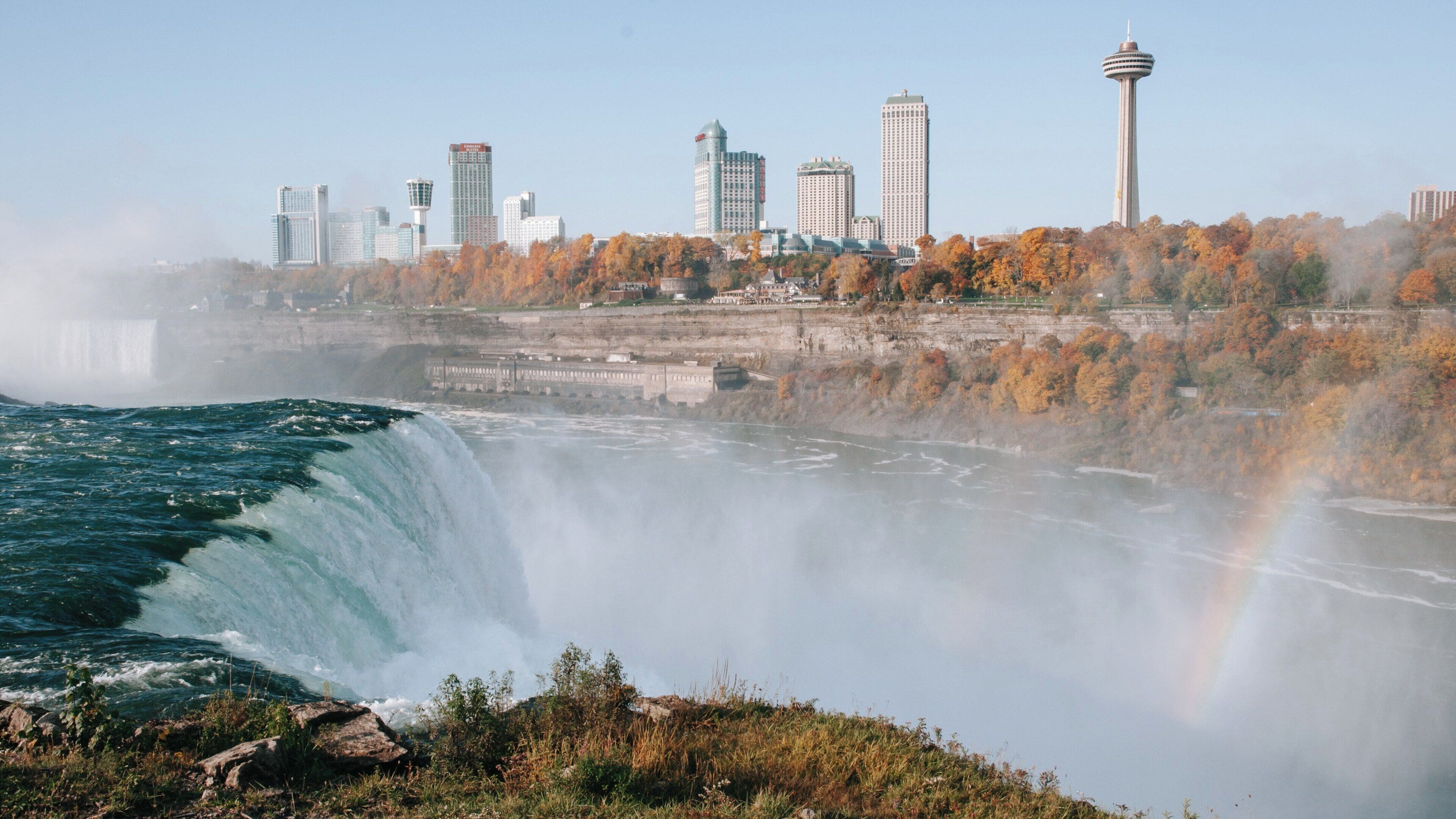 Bridal Veil Falls cascading gracefully amidst the stunning autumn landscape of Niagara Falls, New York, showcasing nature's beauty and city skyline