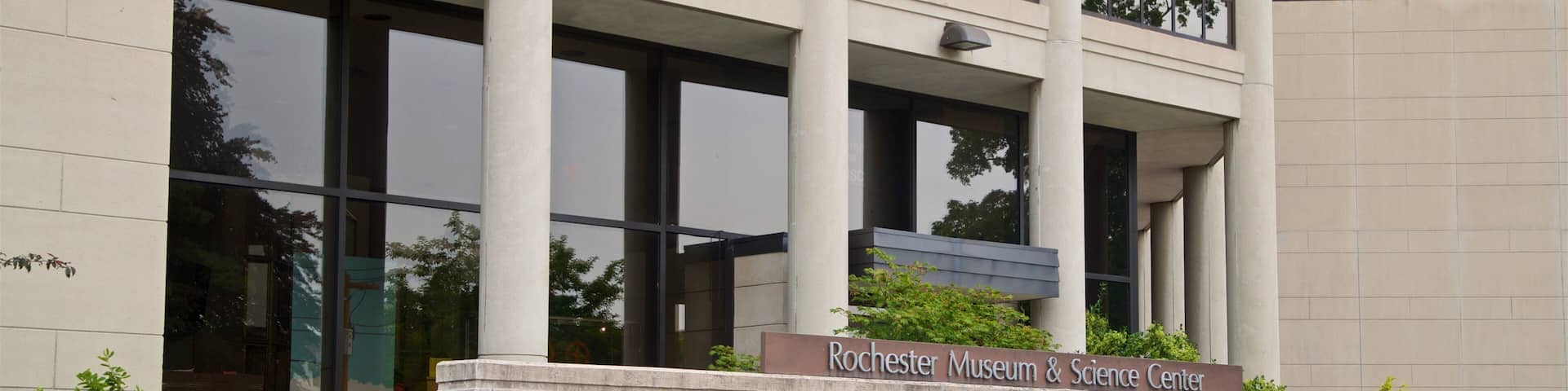 A modern building with large windows and a sign reading "Rochester Museum & Science Center".