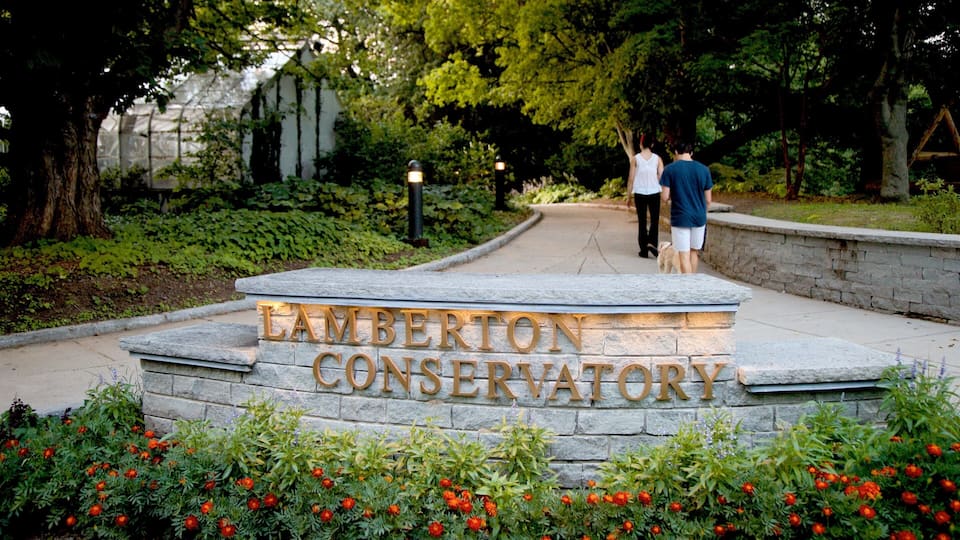 Highland Park showing signage, hiking or walking and a garden