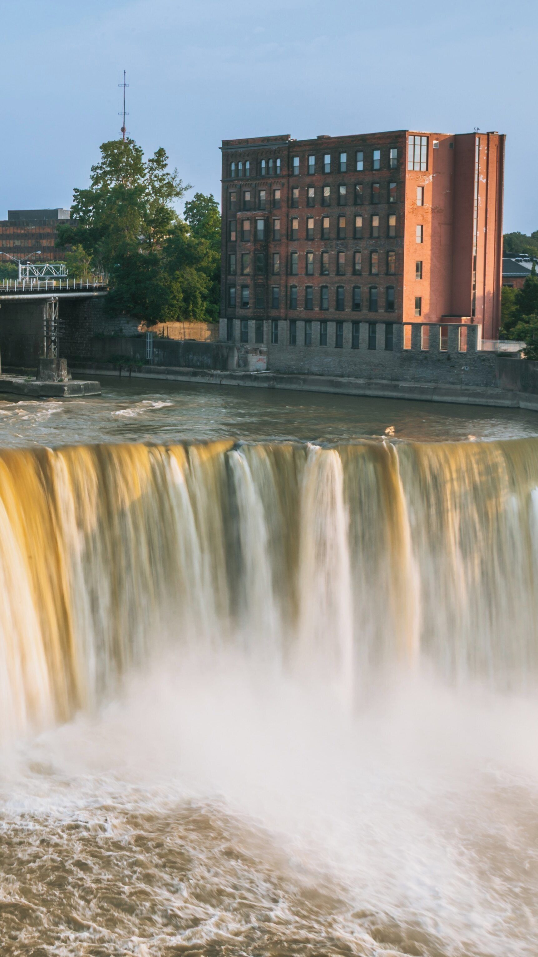 Exploring the majesty of Genesee River's High Falls in downtown Rochester, New York, highlighted by the stunning water cascades and historic architecture