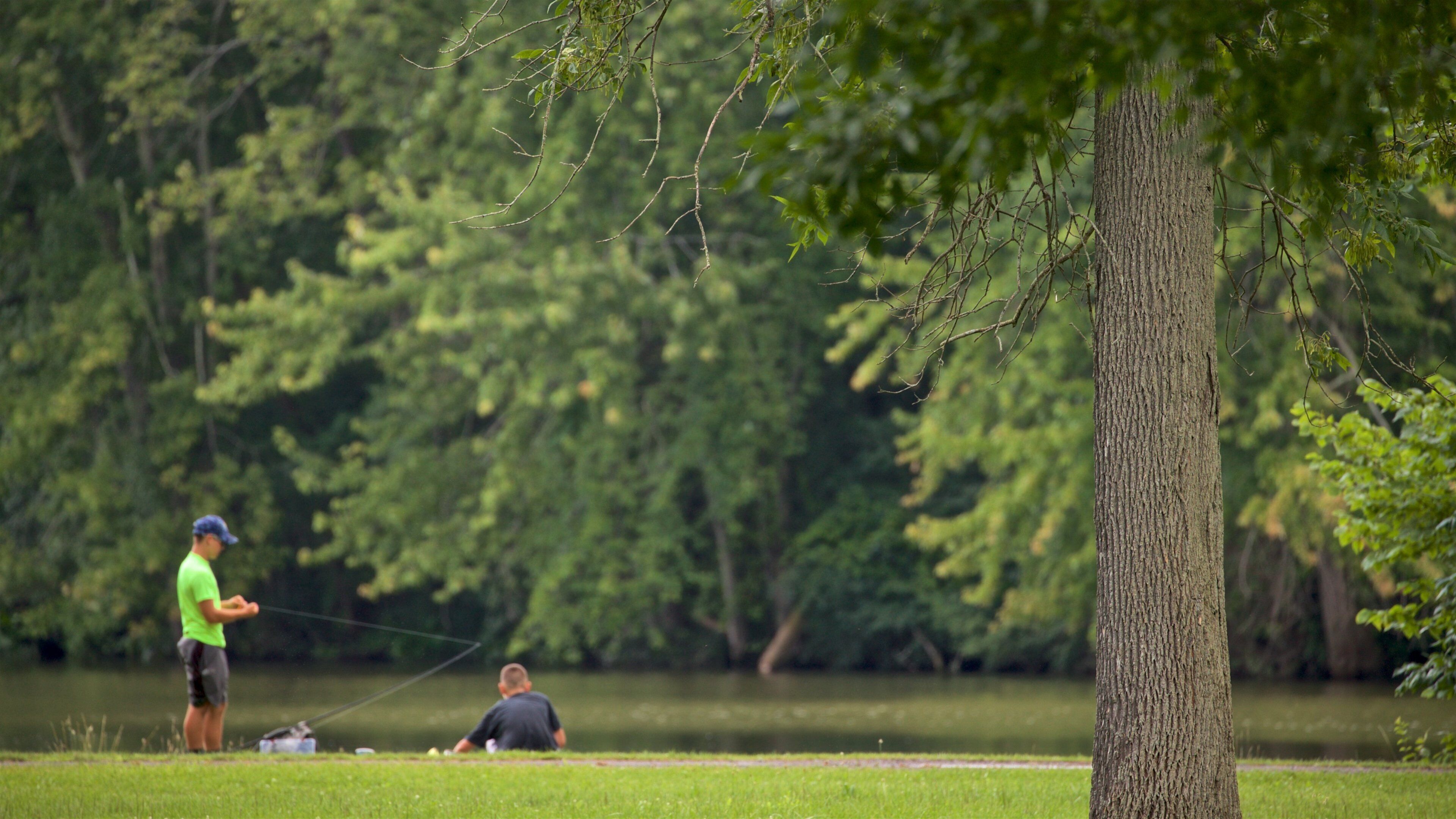 Lake Onondaga featuring fishing and a park as well as a family
