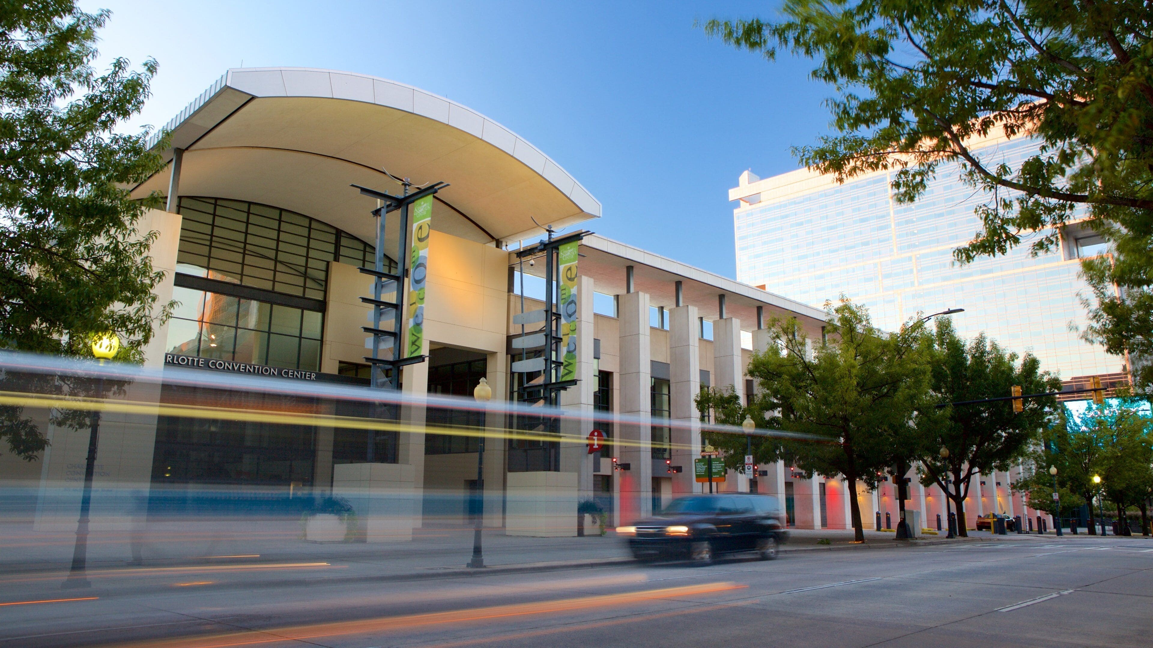 A modern building with a curved roof and a sign that reads "RLOTT CONVENTION CENTER".