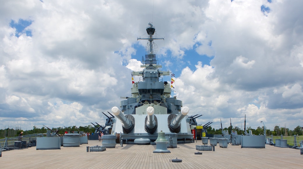 Battleship North Carolina featuring heritage elements as well as a small group of people