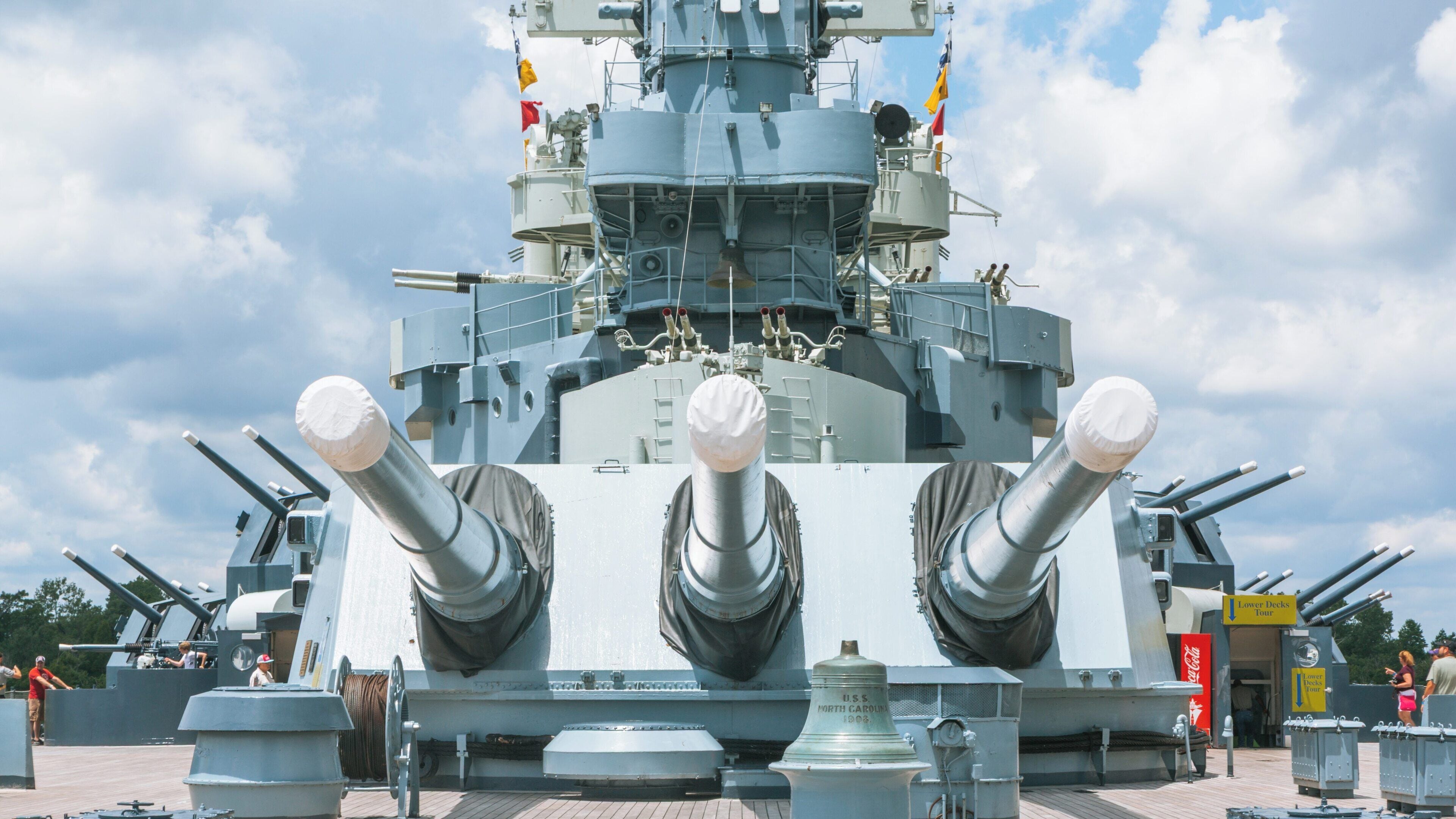 Battleship North Carolina showcases its impressive weaponry at Leland, North Carolina under a bright sky