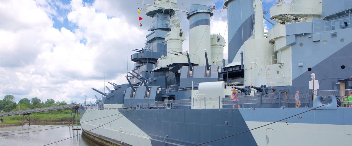 Battleship North Carolina featuring heritage elements as well as a small group of people