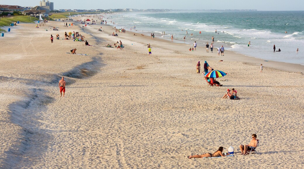 Wrightsville Beach which includes a beach and general coastal views as well as a large group of people
