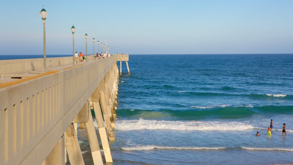 Wrightsville Beach featuring a sandy beach and general coastal views as well as a small group of people