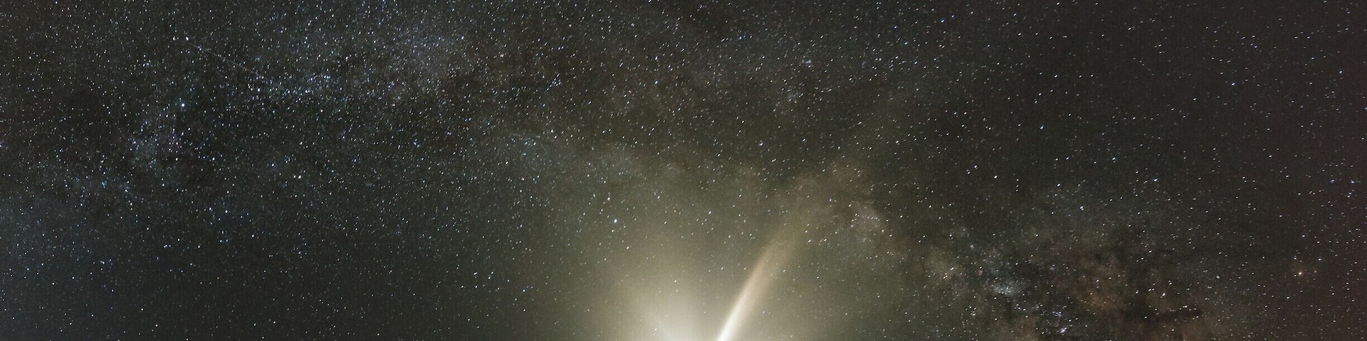 My first attempt at a serious panorama of the Milky Way, our home galaxy. Cape Hatteras Lighthouse provides an ideal location since it faces the right direction to compose such a panorama while maintaining the balance in the image.
This shot is composed of 6 vertical shots shot at 30 degrees of rotation and merged in Photoshop. Added to the usual difficulties of shooting and composing a panorama at night, this night was crazy hot with nighttime temperature in the mid 80s, no breeze and humidity so high that the lens had to be wiped after every exposure. On top of it, the mosquitoes had a field day running rings around me and no amount of bug spray helped. But in spite of all that, I managed to walk away with an image and experience that does appeal to me.