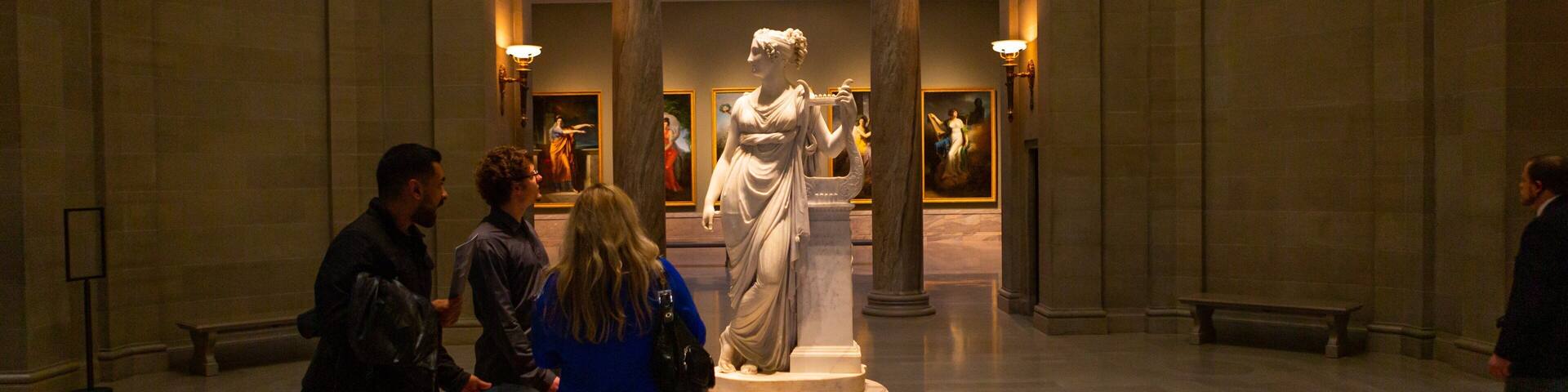 Cleveland Museum of Art which includes a statue or sculpture and interior views as well as a small group of people