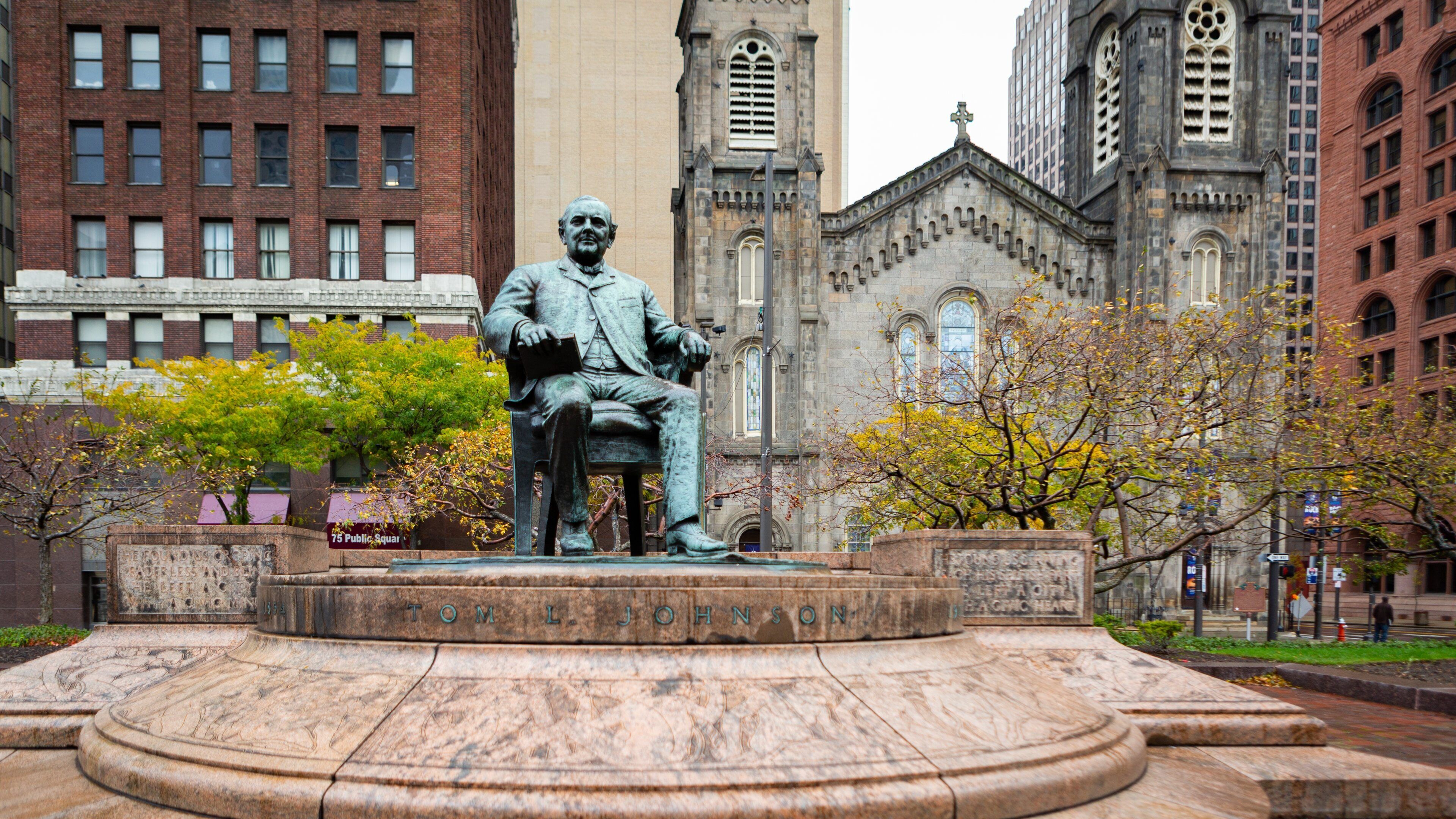 Old Stone Church featuring heritage architecture, a statue or sculpture and a city