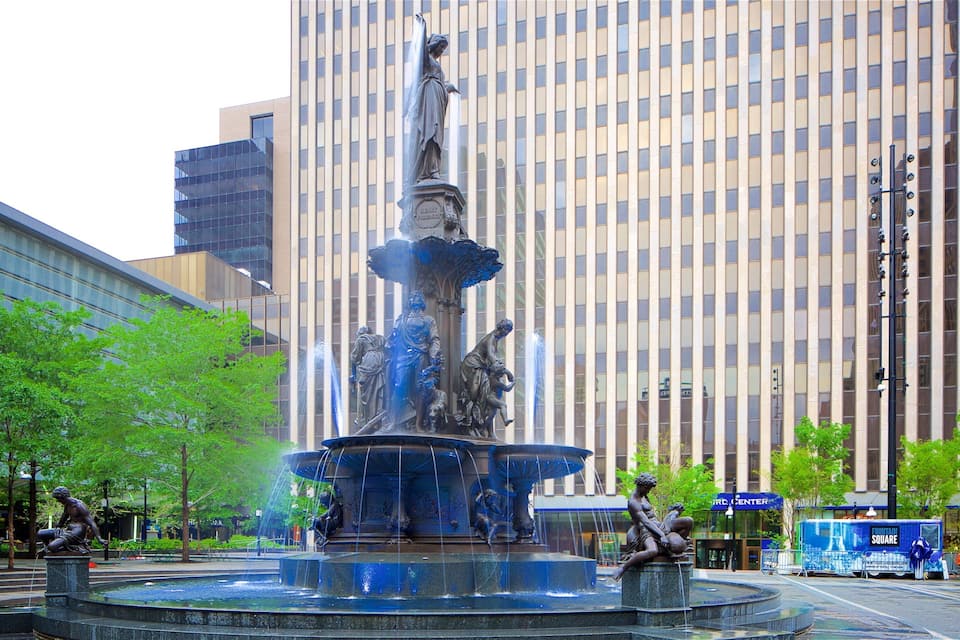 A fountain with statues in a city square.