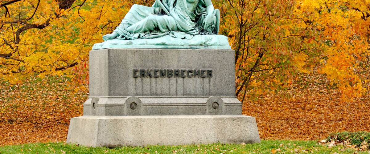 Spring Grove Cemetery featuring a statue or sculpture, a cemetery and autumn leaves