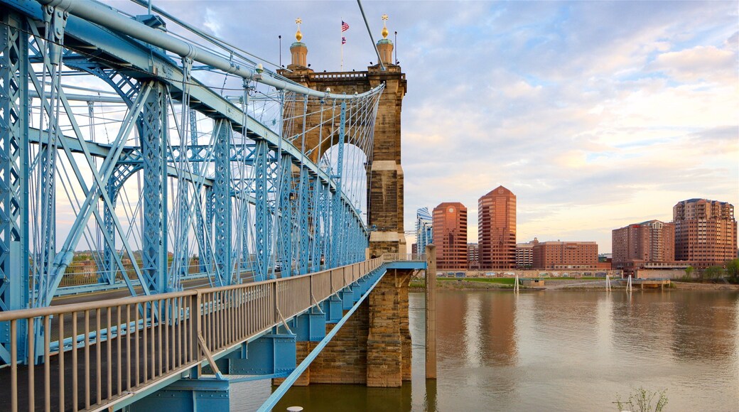 John A. Roebling Suspension Bridge showing a river or creek, heritage elements and a sunset