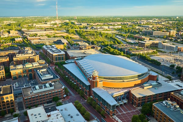 Golden sunrise over Nationwide Arena and land around it in aerial of Columbus Ohio