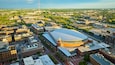 Golden sunrise over Nationwide Arena and land around it in aerial of Columbus Ohio