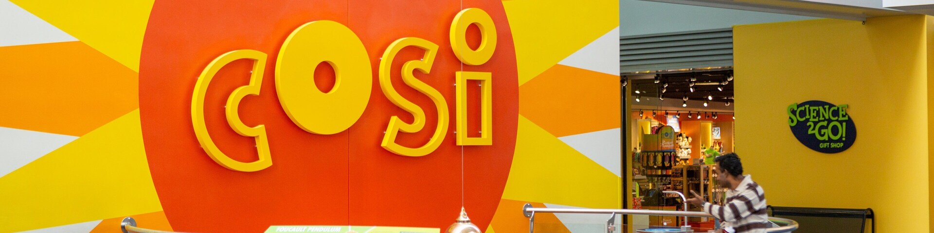 COSI featuring signage and interior views as well as a family