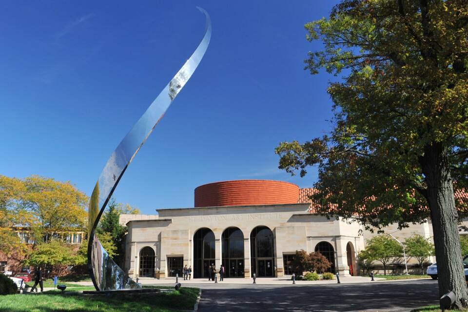 The Dayton Art Institute with a large sculpture and a red circular building.
