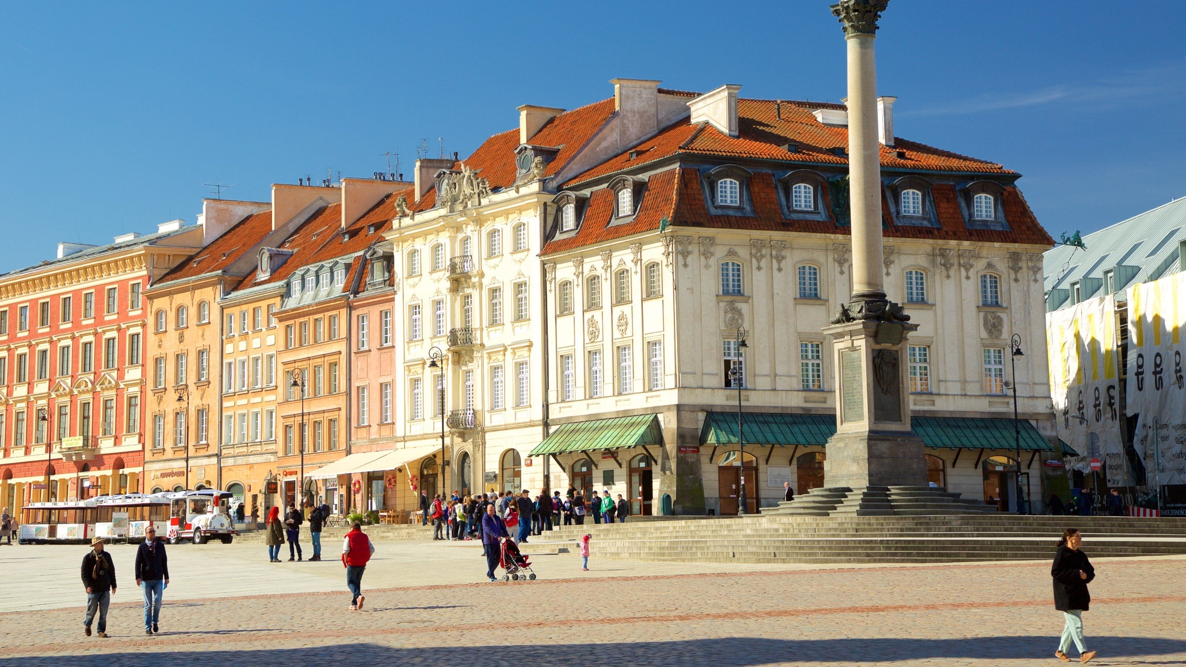 A historic square with a central monument, surrounded by colorful buildings with classic architecture.