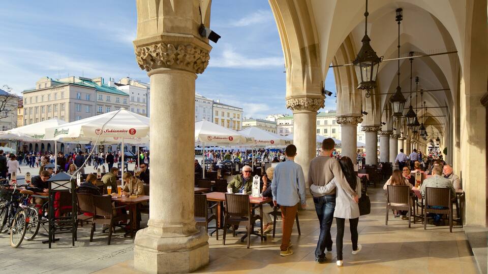 Cloth Hall featuring outdoor eating as well as a small group of people