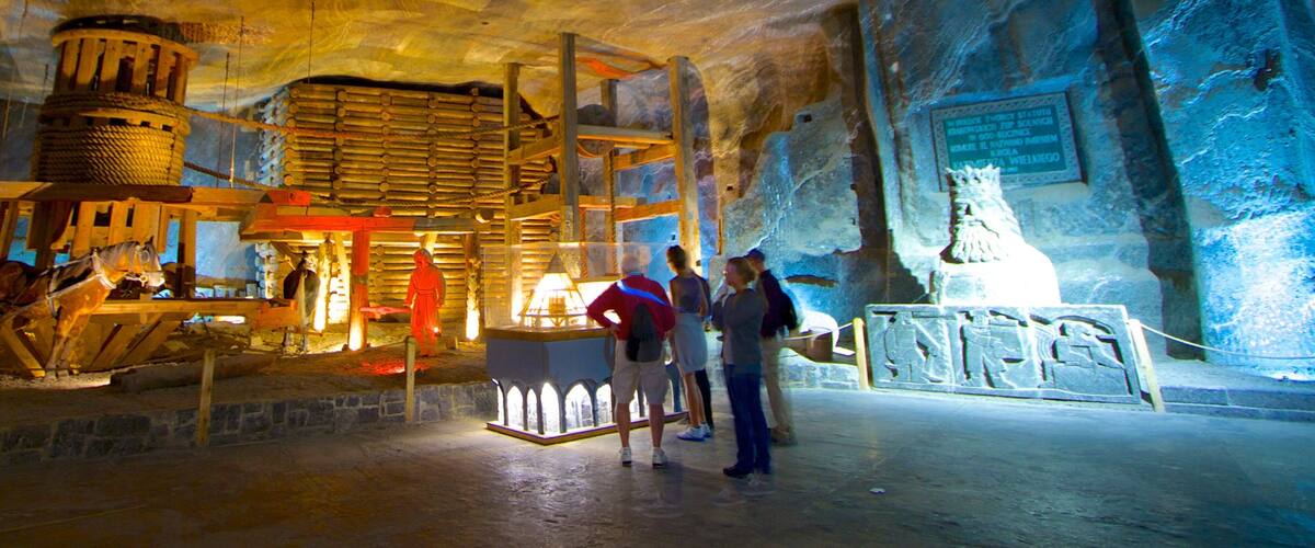 A cave interior with wooden structures and a statue.