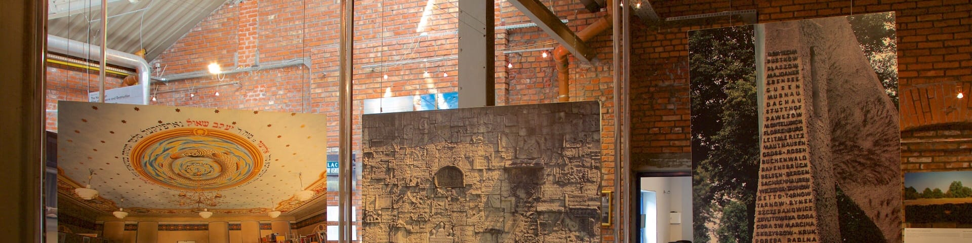A museum interior with brick walls, glass display cases, and informational plaques.