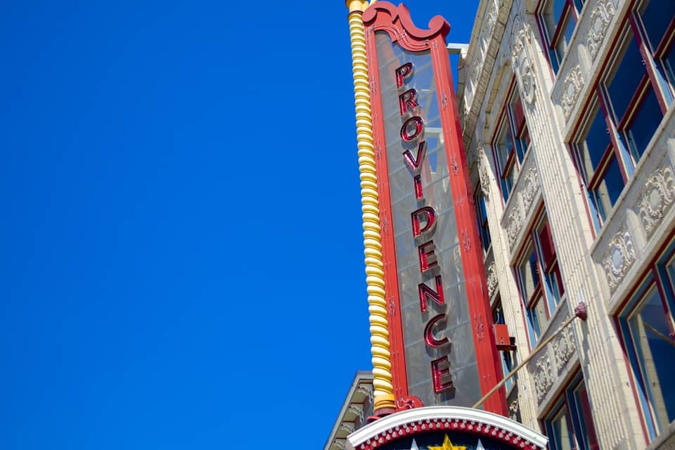 A building with a red and yellow marquee sign that reads "POTTER'S COVE."