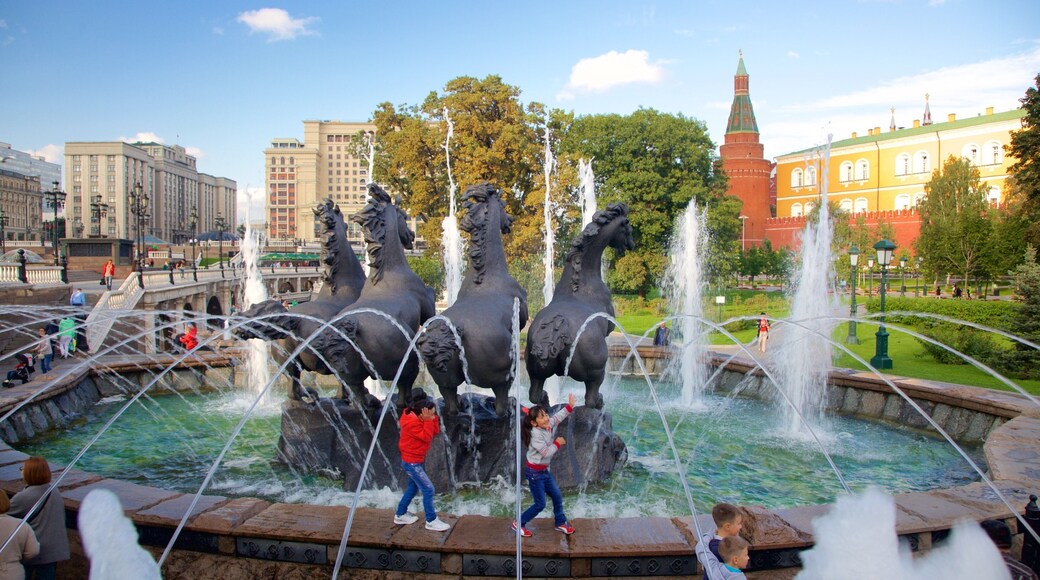 Alexander Gardens featuring a fountain and a statue or sculpture as well as children