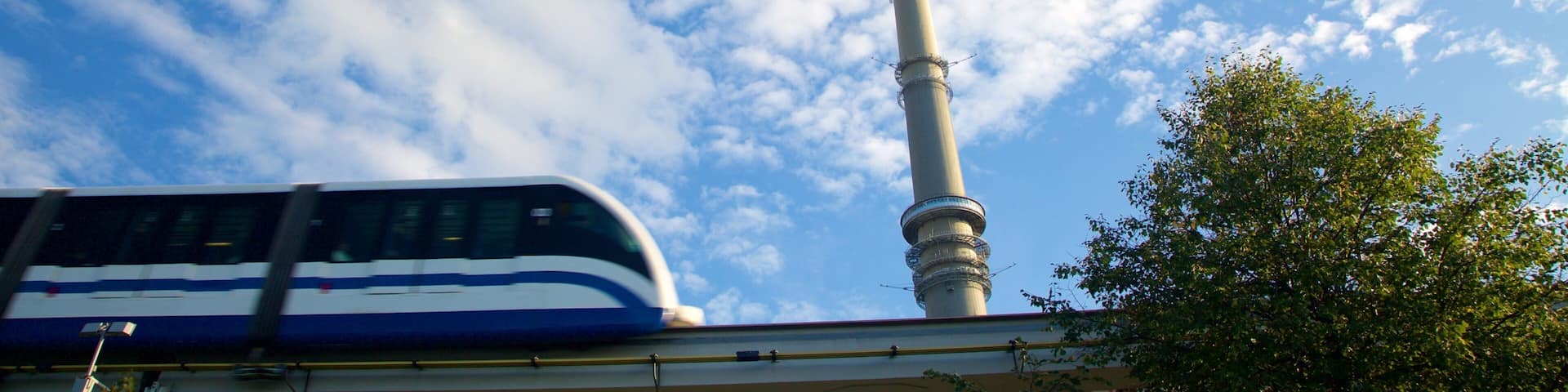 A tower with a spire against a blue sky with clouds.
