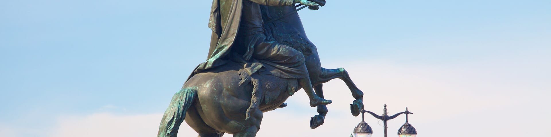 A statue of a man on horseback, mounted on a pedestal with inscriptions.