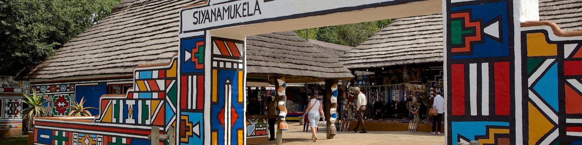 Lesedi Cultural Village featuring a small town or village and signage