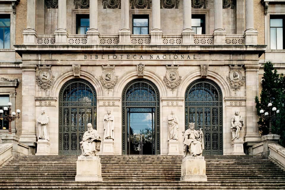 The Biblioteca Nacional building with ornate columns, statues, and a grand entrance.