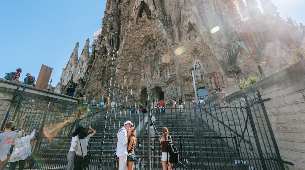 Sagrada Familia which includes a sunset and heritage architecture as well as a couple