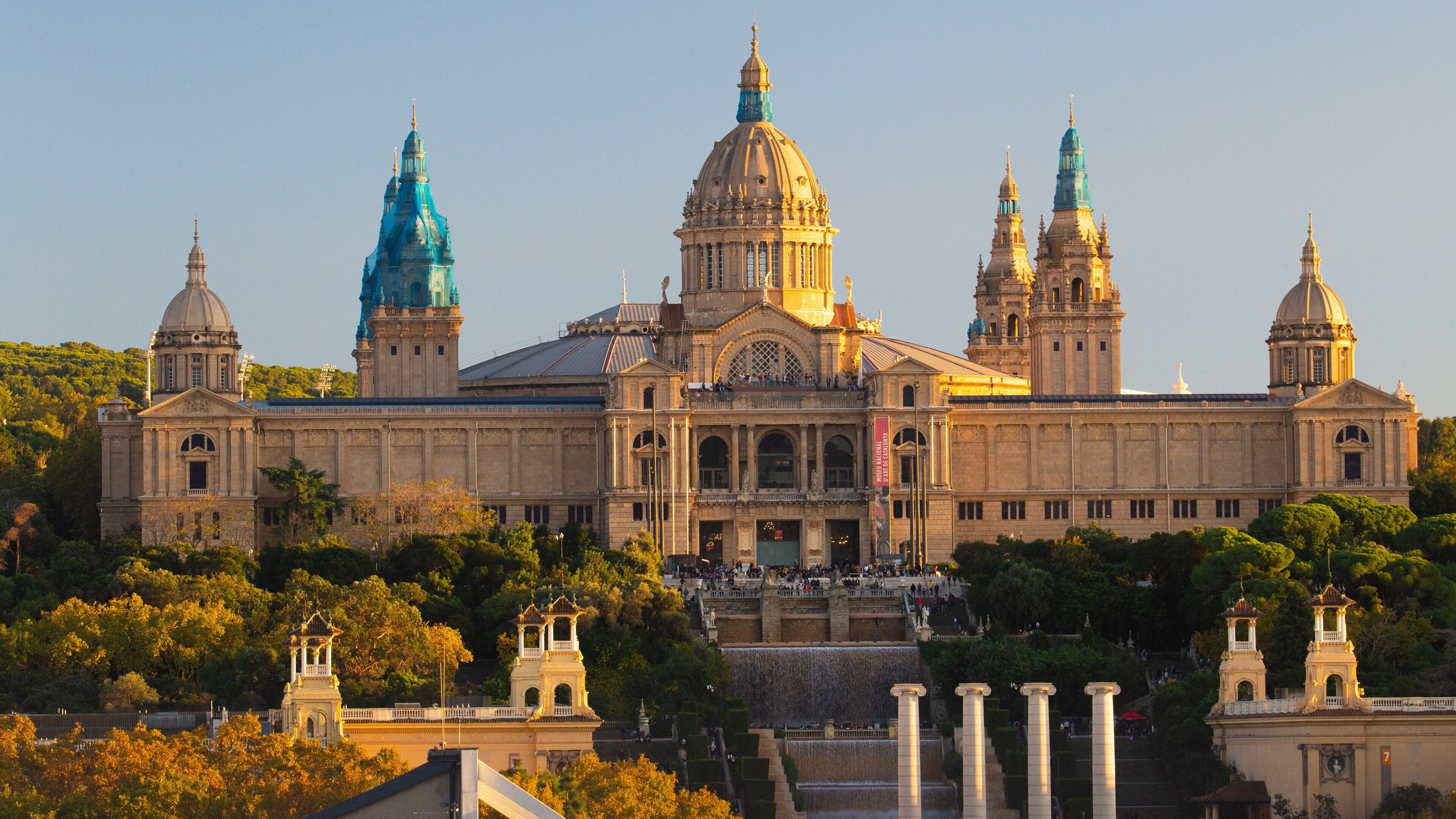 National Art Museum of Catalonia which includes a sunset and heritage architecture