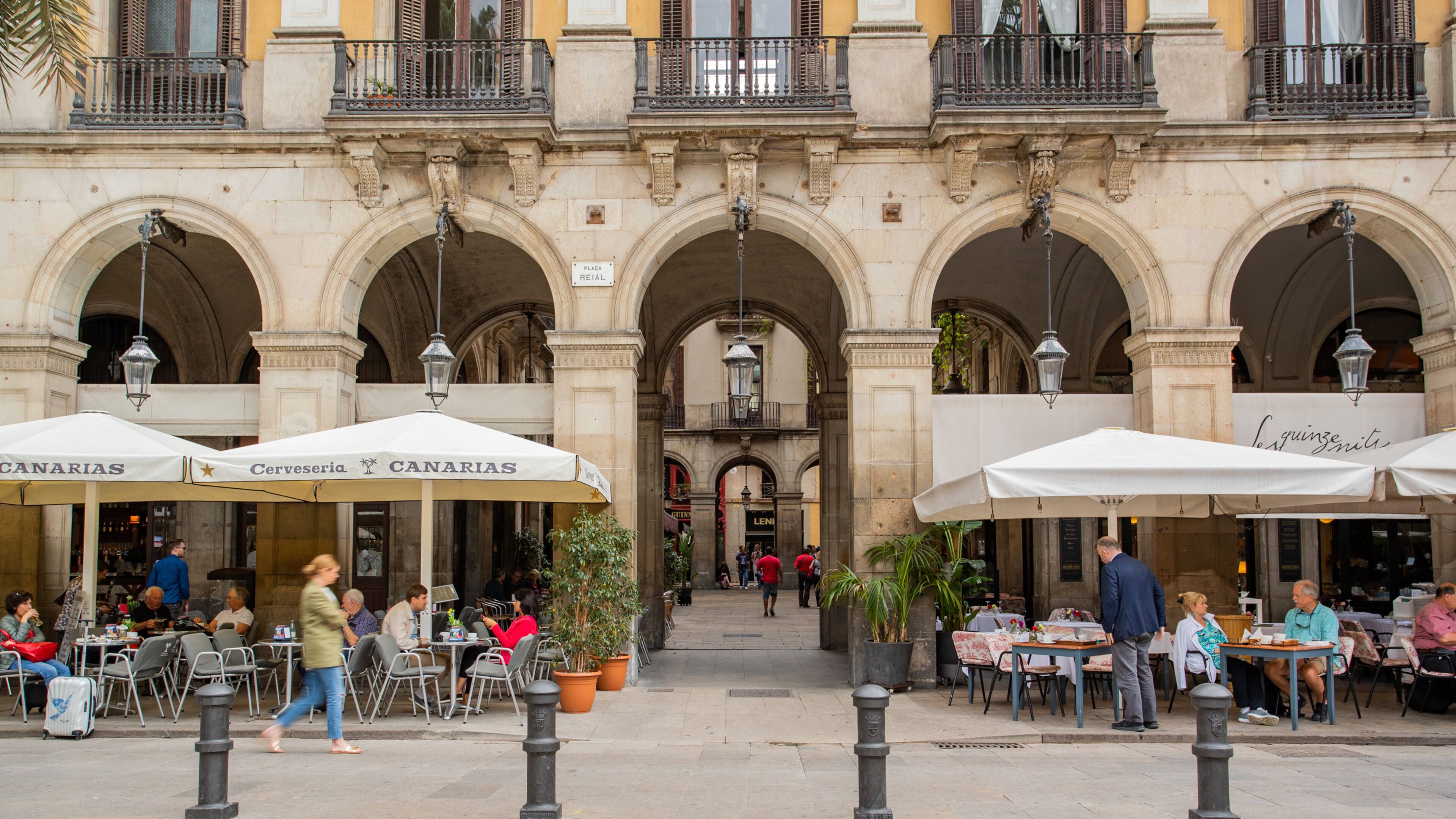 Placa Reial featuring outdoor eating as well as a small group of people