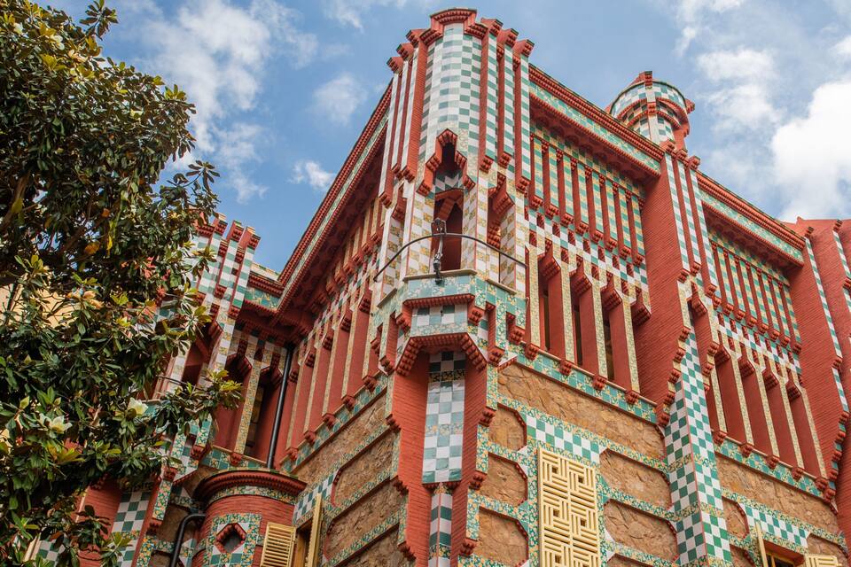 A building with intricate checkered patterns and red and green colors.