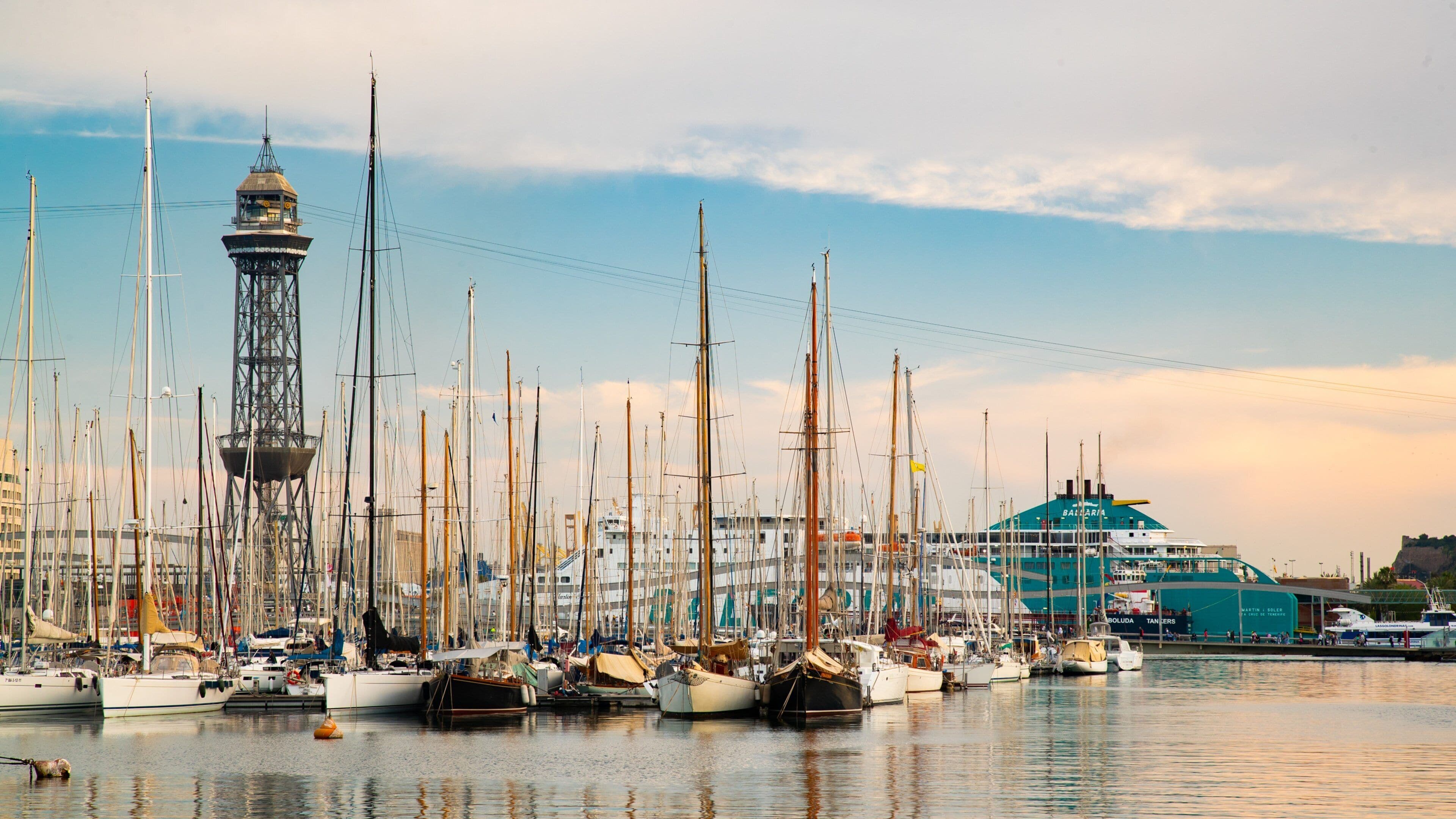 Port Vell showing a sunset and a bay or harbor