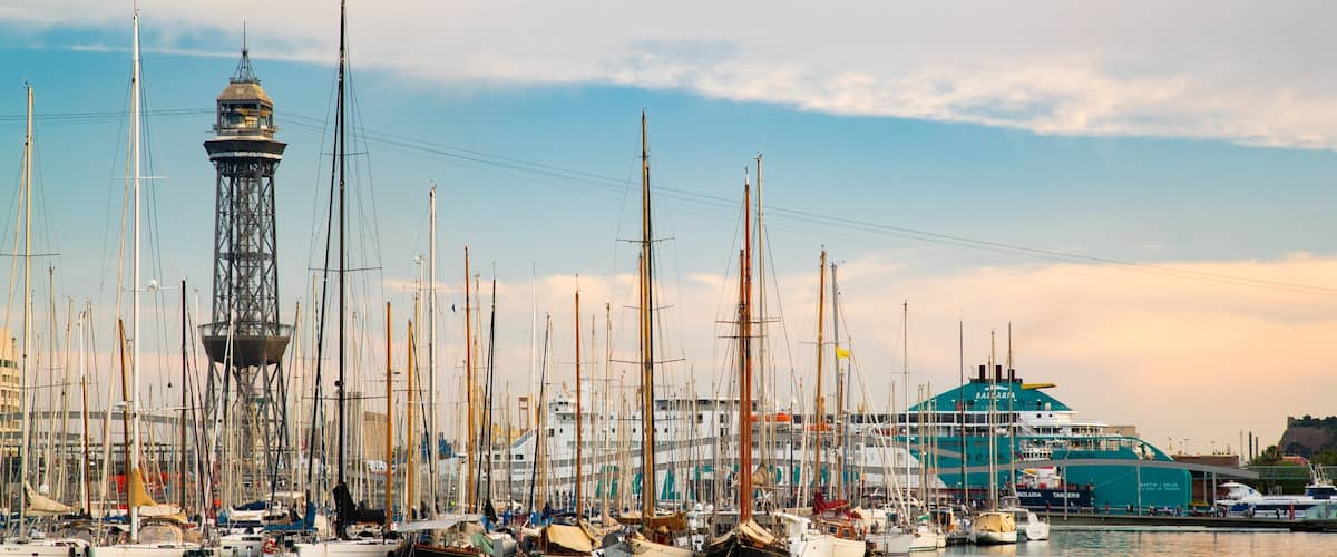 Port Vell showing a sunset and a bay or harbor