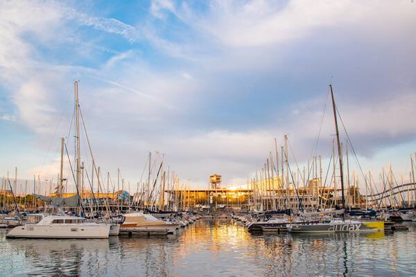 Port Vell which includes a sunset and a bay or harbor