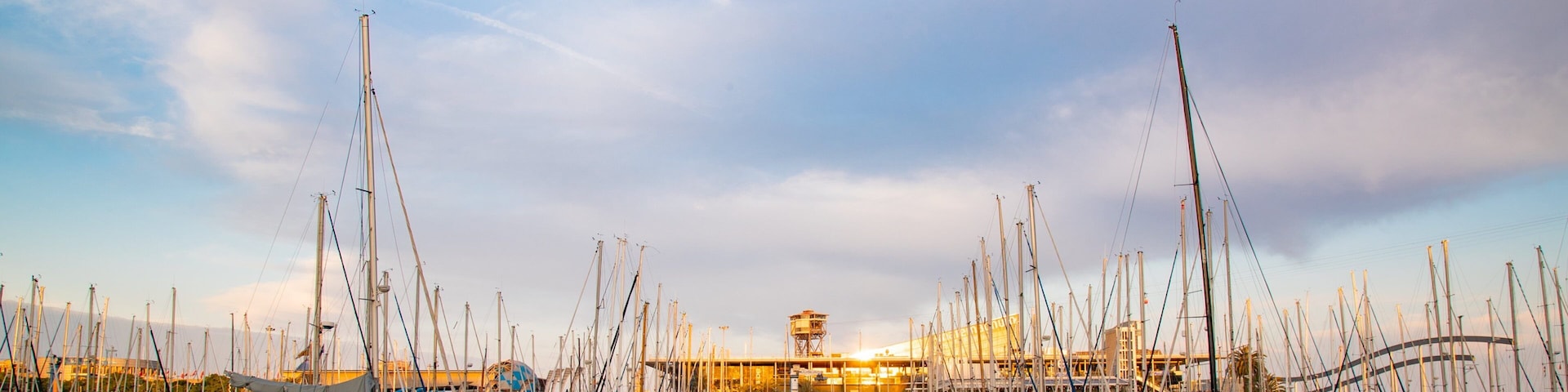 Port Vell which includes a sunset and a bay or harbor