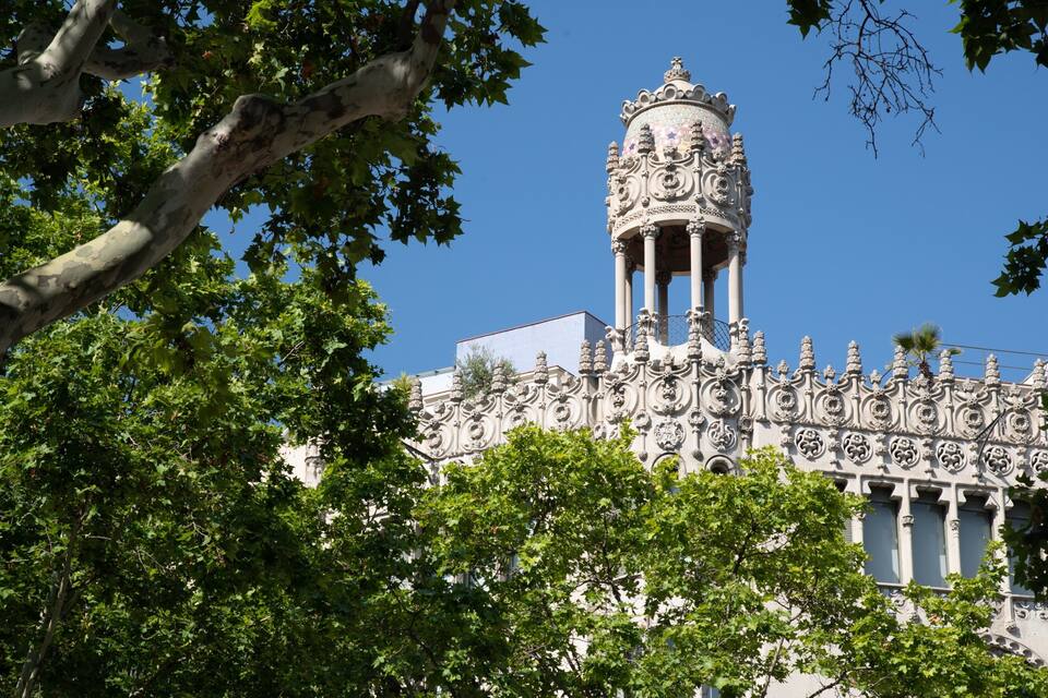 A historic building with ornate architecture, including a tower with intricate designs and a dome.