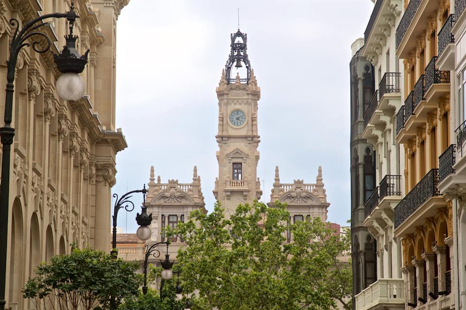 A historic building with a clock tower, ornate balconies, and classical architecture.