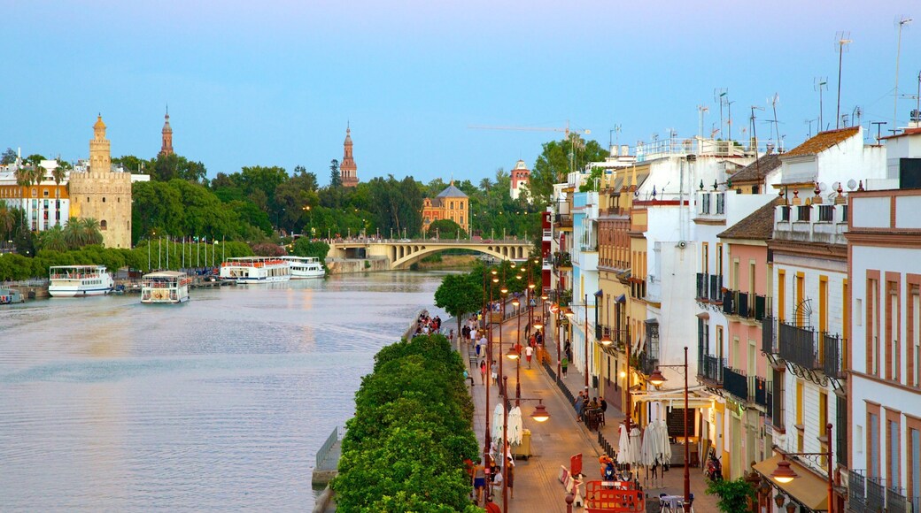 Triana Bridge showing a river or creek, street scenes and a city