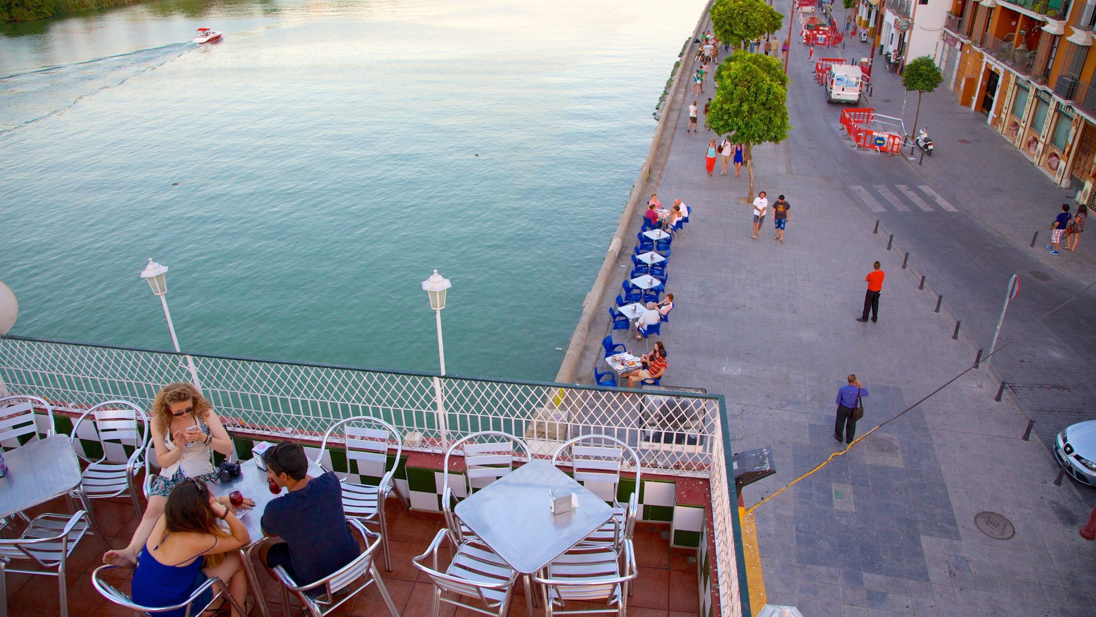 Triana Bridge showing outdoor eating, a river or creek and street scenes