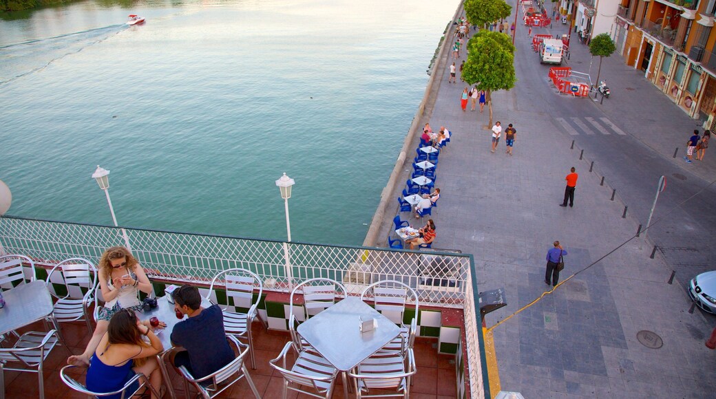 Triana Bridge showing outdoor eating, a river or creek and street scenes
