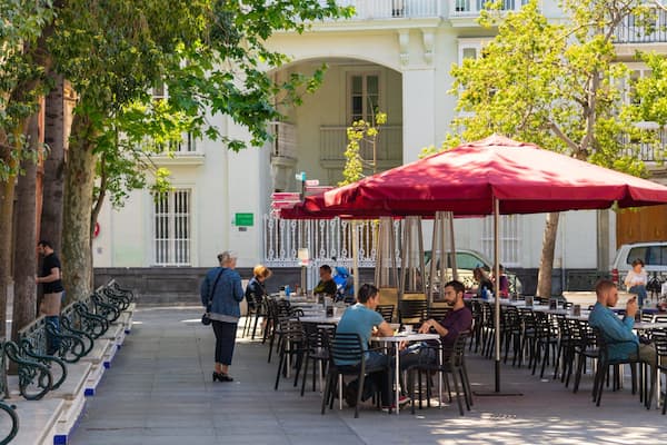 Plaza de Mina which includes outdoor eating as well as a small group of people
